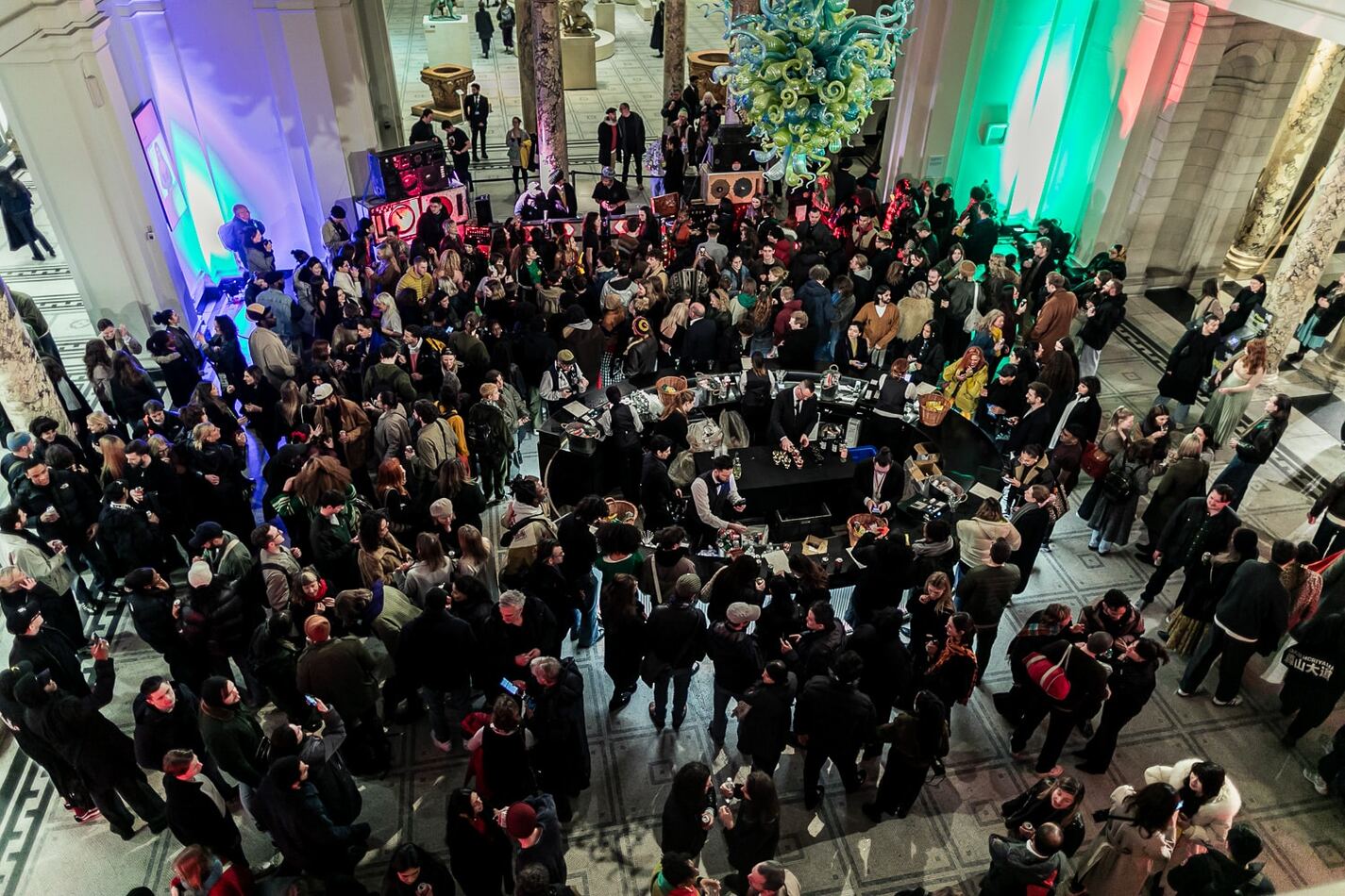 An aerial shot of a crown of people attending an indoor event.